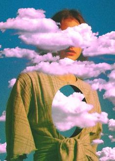 a woman is standing in the middle of clouds