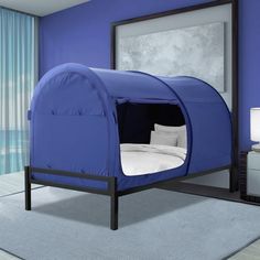 a bedroom with a blue tent bed in it