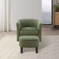 a green chair and footstool sitting on a rug in front of a window