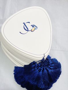 several white and blue coasters stacked on top of each other with the letter j on them