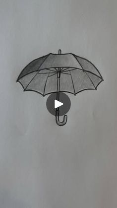 an umbrella is suspended upside down in the air with a video play button below it