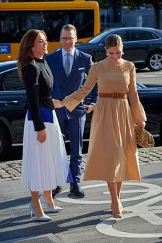 two women and a man are shaking hands