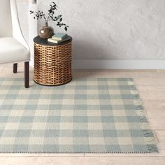 a chair and table in a room with a rug on the floor next to it