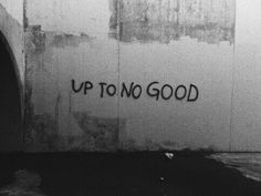 graffiti on the side of a wall that says up to no good in black and white