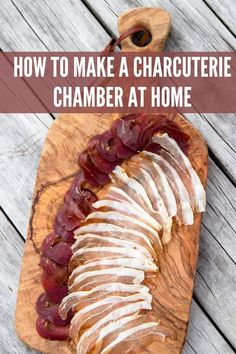 a wooden cutting board topped with sliced meat and text overlay reads how to make a charcuterie chamberer at home