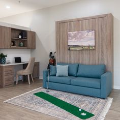 a living room filled with furniture and a golf green