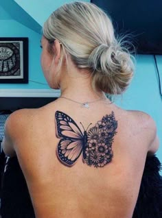 a woman with a butterfly tattoo on her back