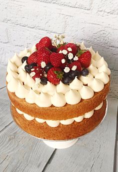 a cake with white frosting and strawberries on top