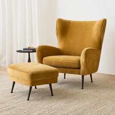 an orange chair and ottoman in a living room