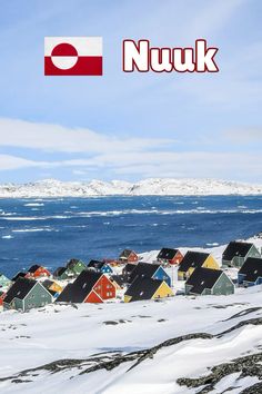 there are many small houses in the snow by the water and mountains with a flag that says nuuk