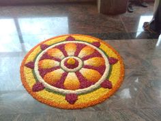 a colorfully decorated rug on the floor in a hotel lobby with people walking by