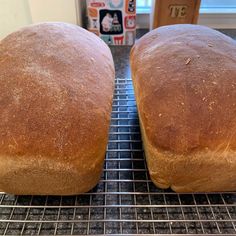 two loaves of bread cooling on a rack