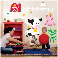 a woman and child playing with toys in a room filled with farm animals on the wall