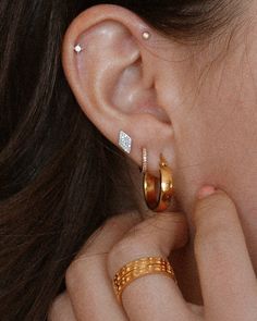 a close up of a person's ear with two rings on top of it