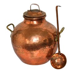 an old copper pot and ladle are on display