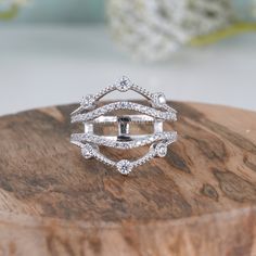 a diamond ring sitting on top of a wooden stand