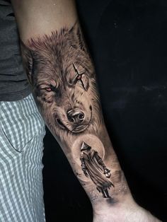 a man with a wolf tattoo on his arm