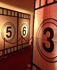 the numbers are on display in front of red carpeted flooring and white walls