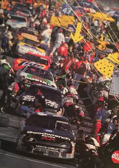 a group of cars driving down a race track