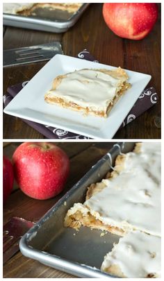 an apple cake with white frosting on top and apples in the background next to it