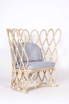 a chair that is made out of bamboo and has a blue cushion on the back