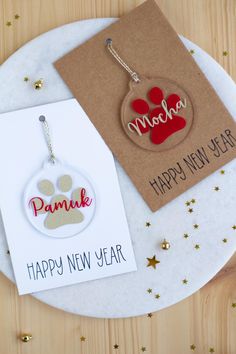 two new year's cards on a table