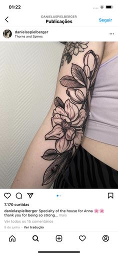 a woman's arm with flowers on it