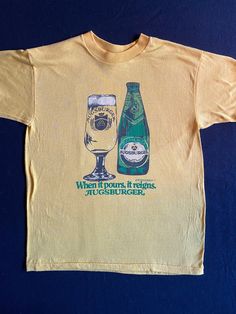 "Vintage beer shirt, cool graphics for a Company that no longer exists.  Clever take off of Morton Salt saying, When it Pours, it reigns AUGSBURGER.  Great beer lovers, beer collector t shirt.  Please note, the shirt is bright yellow as seen in the photo of the label. Excellent vintage condition  Modern size small Label: Fine Apparel T Fine by R & D 50/50 cotton/polyester size M Measurements: Pit to pit: 17\" Length: 24\"" Vintage Beer Tshirts, Eclectic Vintage Fashion, Vintage Tee Shirt Designs, Retro T Shirts, Beer Merch, Brewery Merch, Yellow Shirt, Vintage Shirt, Vintage T Shirt Design