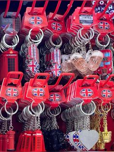 many different types of key chains and other items on display in a store window,