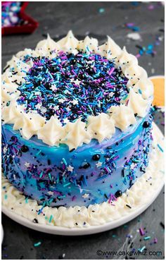 a blue and white cake with sprinkles on it