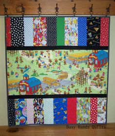 a colorful quilt hanging on the wall