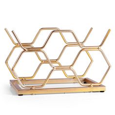 a gold metal rack with three sections on it and two shelves in the shape of hexagonals