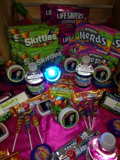 various candy items on a pink table cloth