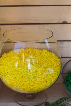 a glass bowl filled with yellow and green candies