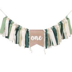 a banner with the word one hanging from it's sides and tassels