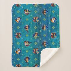 the little mermaids blanket is shown on top of a white and blue blanket with an aqua