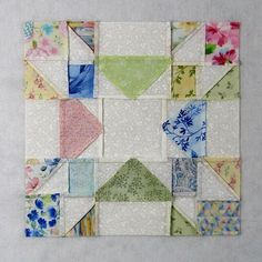 a piece of fabric that has been made to look like a patchwork quilt with flowers on it