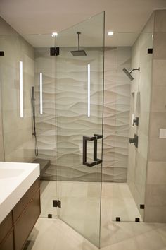 a bathroom with a walk in shower next to a sink