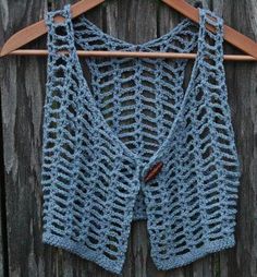 a blue knitted sweater hanging on a wooden hanger