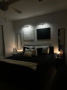 a large bed sitting under two lights in a bedroom