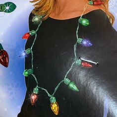 a woman wearing a black dress with christmas lights on it