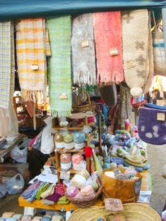 an outdoor market with various items for sale