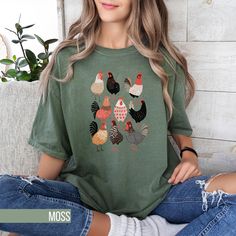 Add some fun to your wardrobe with this cute Chicken Print T-Shirt! Perfect for those who adore farm animals, this tee features a cute array of chickens in various patterns and poses. The playful design is screen printed on a high-quality, soft fabric, making it a comfortable and stylish choice for everyday wear. Whether you're running errands or visiting a local farm, this unisex shirt is sure to get you compliments from fellow poultry enthusiasts. Available in multiple sizes to ensure a good f Cute Cotton T-shirt With Funny Print, Novelty Short Sleeve Tops With Funny Print, Short Sleeve Tops With Funny Print, Cute Crew Neck Top With Funny Print, Playful Crew Neck Tops, Playful Soft-washed Crew Neck Tops, Green Novelty Short Sleeve Top, Green Short Sleeve Novelty Top, Green Crew Neck Novelty Top