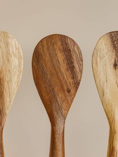 three wooden spoons lined up next to each other