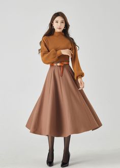 "Elevate your winter style with our brown wool swing midi skirt. The warm brown hue adds a touch of classic charm, and the premium wool fabric provides both style and warmth. The carefully crafted buttons create an elegant and dynamic look. This versatile midi skirt effortlessly transitions from day to night, making it a must-have choice for those who seek both fashion and coziness. DETAILS: * 30% wool, 30% fiber, 40% polyester * Fully satiny liner * Without pockets * Back zipper closure * Circl Midi Wool Skirt, Custom Skirt, Wool Clothing, Skirt Midi, Wool Skirt, Style Change, Warm Brown, Wool Skirts, Wool Fabric