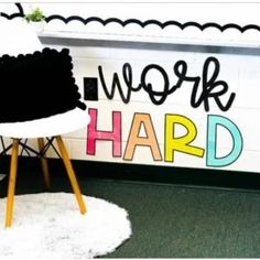 a chair sitting in front of a sign that says work hard