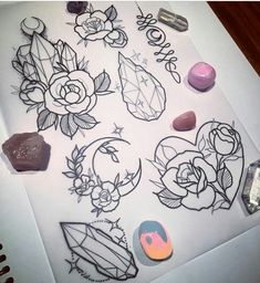 several different types of tattoo designs on a sheet of paper next to some other items