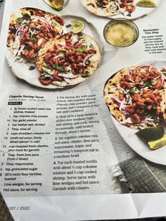 an article in a magazine about food and drinks on the table, including pita breads