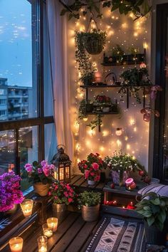 a balcony with potted plants, candles and lights on the windowsills is lit up by string lights