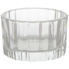 an empty glass cup sitting on top of a white table